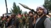 AFGHANISTAN -- Armed men attend a gathering to announce their support for Afghan security forces and that they are ready to fight against the Taliban, on the outskirts of Kabul, June 23, 2021